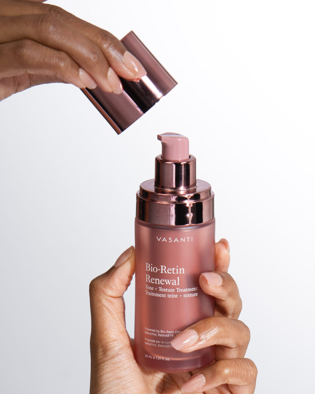 Hands lifting the cap off the Bio-Retin Renewal airless pump