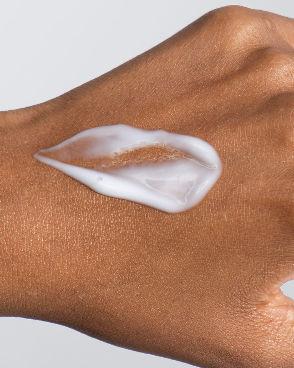 A swipe of Bio-Retin Renewal's water-cream on the back of a deep-toned hand